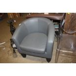 A faux leather tub chair