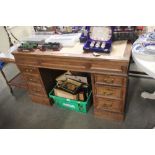 An oak pedestal writing desk