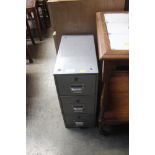 A metal three drawer filing chest of narrow propor