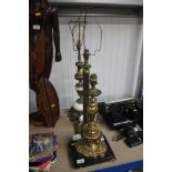 Three ornate brass table lamps