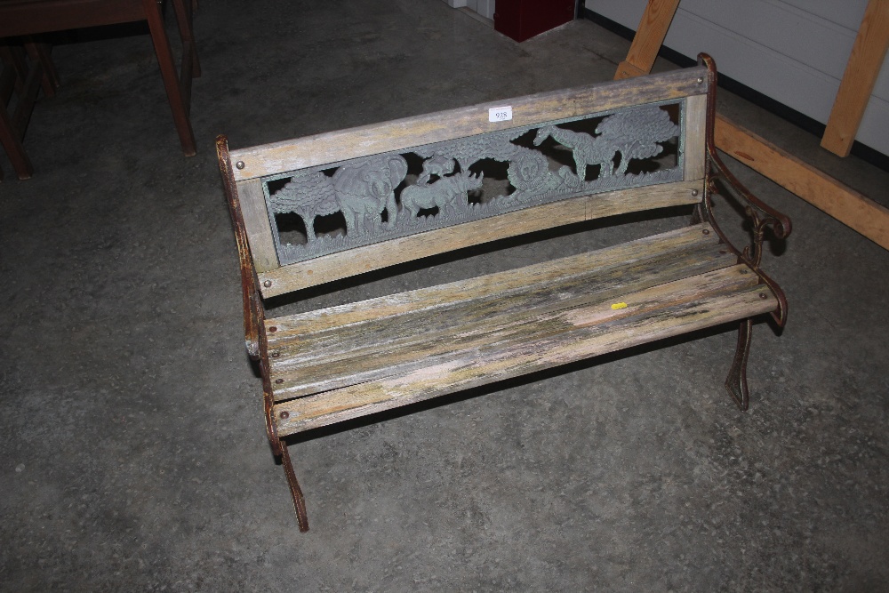 A wood and metal garden bench decorated with Afric