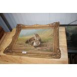 A gilt framed oil on board study depicting otters