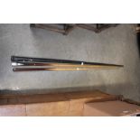 Two pool cues and one cue contained in metal case