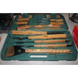 A barbeque cleaning set and utensils in fitted cas