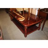 A reproduction mahogany two tier coffee table