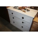 A white painted pine chest fitted three long drawe