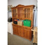 A modern pine dresser raised on cupboard base