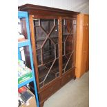 A mahogany glazed bookcase fitted two drawers belo