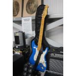 A blue Stagg Stratocaster electric guitar with str