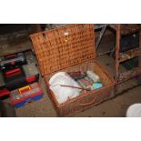 A large wicker picnic hamper and contents