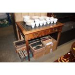 An oak leather topped writing desk, fitted single