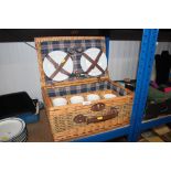 A wicker picnic hamper and contents