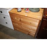 A pine chest fitted three long drawers