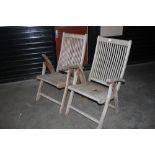 A pair of teak garden chairs