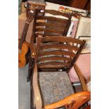 A pair of ladder back carver chairs