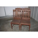 A set of four teak garden chairs