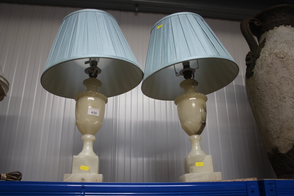 A pair of marble effect table lamps and shades