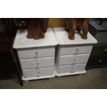 A pair of white painted bedside chest fitted three