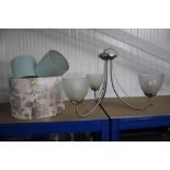 A hanging light fitting and a quantity of lamp sha