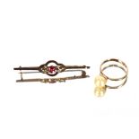 A 9 carat gold ring, set with a single pearl and a yellow metal seed pearl and ruby set brooch, (2)