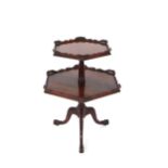 A carved mahogany two tier dumb waiter, raised on a turned baluster column and acanthus tripod base