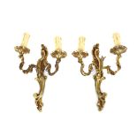 A pair of gilt metal wall appliques in the Louis XV style, the twin scrolling branches with C scroll