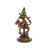 A 19th Century Hindu bronze figure, depicting Khandoba astride a Nandi bull, raised on circular