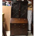 A George III mahogany bureau bookcase, the upper section surmounted by an architectural broken