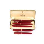 Six maroon Parker pens