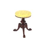 A Victorian walnut revolving piano stool, with floral brocade upholstered seat on baluster column