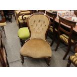 A Victorian walnut spoon back nursing chair, upholstered in faun buttoned dralon, serpentine seat