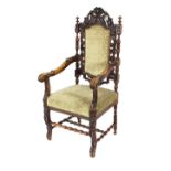 A Victorian carved oak elbow chair, having pierced leaf decorated back, scrolled outswept arms,