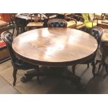 A 19th Century circular rosewood snap top supper table, raised on a circular column with acanthus