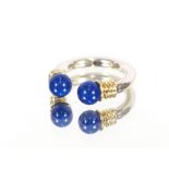 An unusual blue stone silver mounted ring; and an amber silver mounted ring, (2)