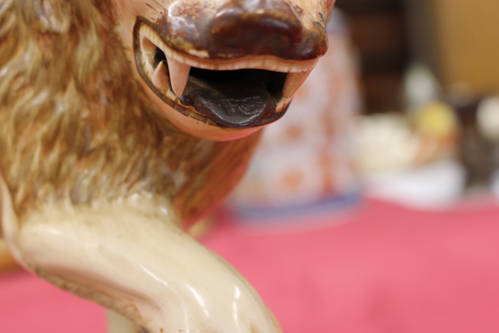 A 19th Century Staffordshire lion figure, right paw resting on a ball, 34cm long - Image 6 of 14