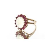 An unusual blue stone silver and yellow metal mounted ring; and a garnet and opal 9 carat gold