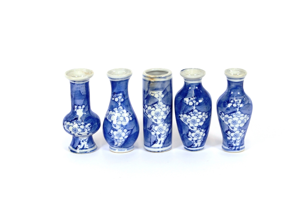 A collection of five Chinese porcelain miniature vases, decorated in under-glazed blue with prunus