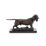 A bronze animalier study of a hound, raised on black onyx plinth, 47cm long
