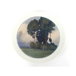 A Meissen Art Deco wall plate, finely painted under glaze landscape with figure, cross swords