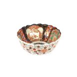 A large 19th Century Imari bowl, decorated in the traditional palette, with scallop borders