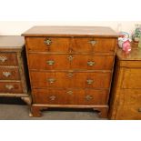 An 18th Century walnut and cross-banded chest, of two short and three long drawers, raised on