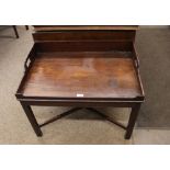 A mahogany butler's tray, the shaped gallery with integral handles, raised on chamfered legs