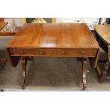 A Regency rosewood and satinwood cross-banded sofa table, fitted two short drawers and opposing