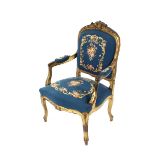 A 19th Century gilt French elbow chair, having carved cresting rail, floral embroidered serpentine