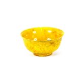 A Chinese yellow porcelain bowl, having raised dragon and flower decoration, six character mark to