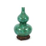 A 19th Century oriental porcelain green ground double gourd shaped vase, finely decorated with