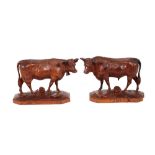 A good quality pair of carved Black Forest cow and bull figures, 16cm long x 13cm high