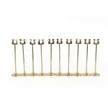A set of 10 brass place setting/menu holder stands, with lyre shaped tops, on turned columns and