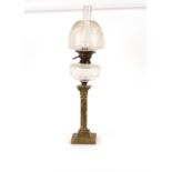 A brass Corinthian column table oil lamp, having etched glass shade, later converted to electricity,