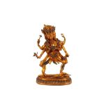 An oriental gilt bronze figure of a fierce three headed god, inset with coloured stones, 29cm high